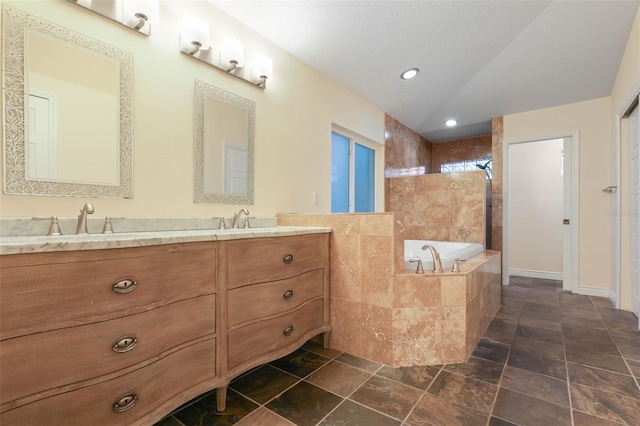 bathroom with double vanity, tiled shower, a sink, and a bath