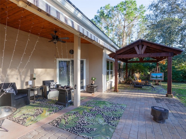 view of patio with ceiling fan and a gazebo