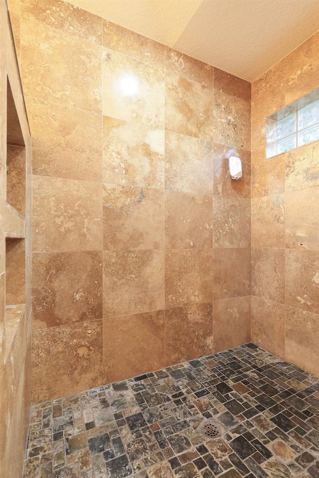 bathroom with a tile shower