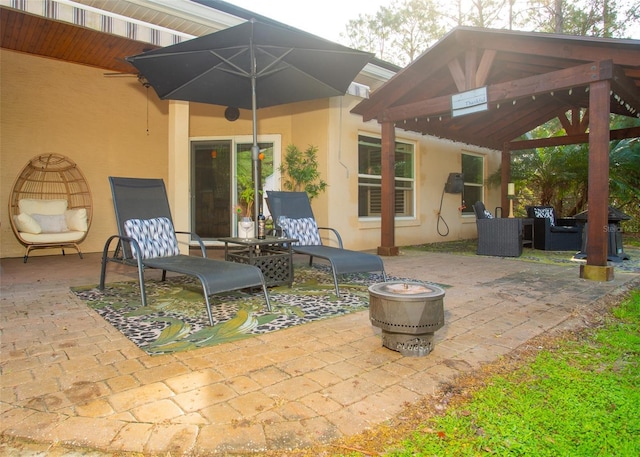 view of patio / terrace featuring a gazebo and an outdoor fire pit