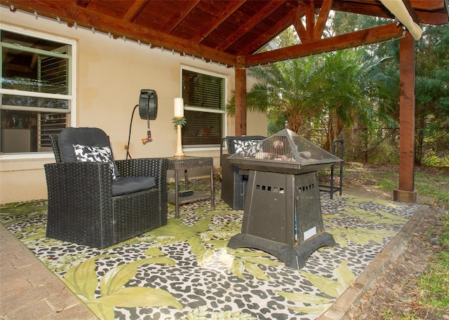 view of patio featuring an outdoor fire pit, fence, and a gazebo