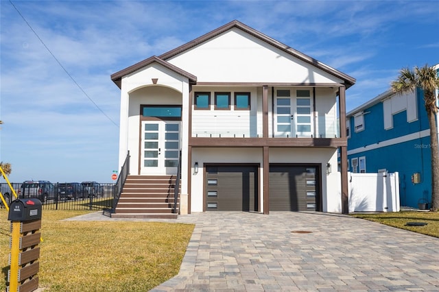 contemporary home featuring a garage and a front lawn