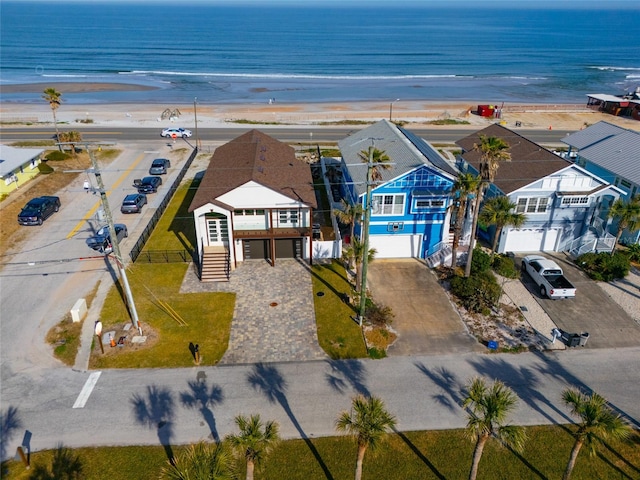 bird's eye view with a water view and a beach view