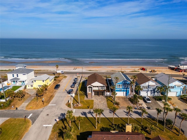 bird's eye view with a water view and a beach view