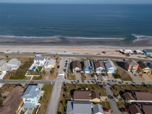 bird's eye view featuring a view of the beach and a water view