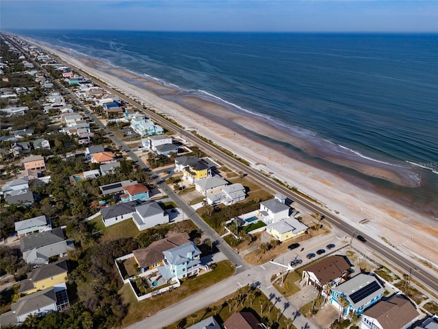 bird's eye view with a water view and a view of the beach