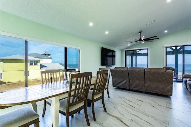 dining room with lofted ceiling, a textured ceiling, and ceiling fan