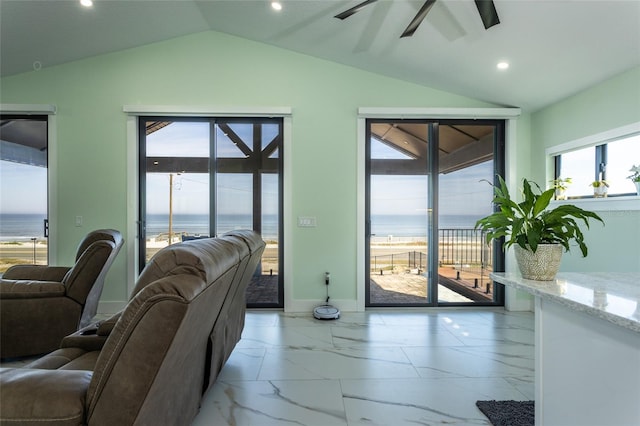 living room with a water view, lofted ceiling, and ceiling fan