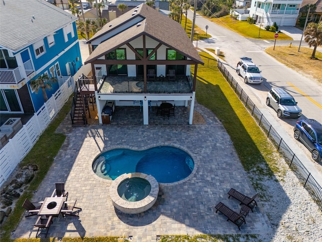 view of pool with an in ground hot tub and a patio area