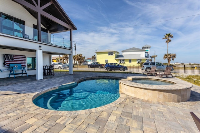 view of pool featuring an in ground hot tub and a patio