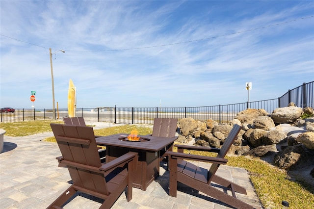 view of patio / terrace featuring a water view and an outdoor fire pit