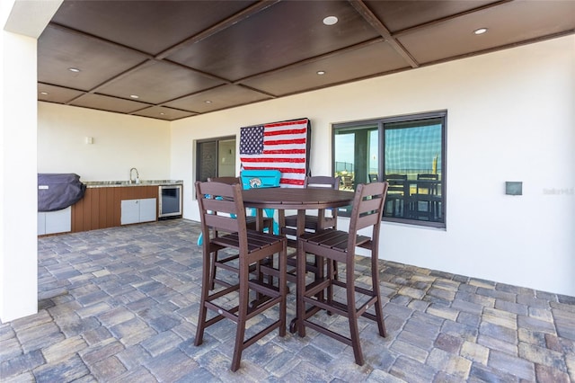 view of patio featuring wine cooler, sink, and an outdoor kitchen