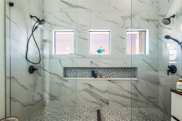 bathroom with a tile shower and a healthy amount of sunlight