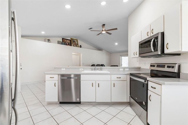 kitchen featuring stainless steel appliances, kitchen peninsula, sink, and white cabinets