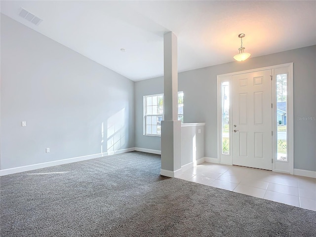 carpeted entryway with lofted ceiling