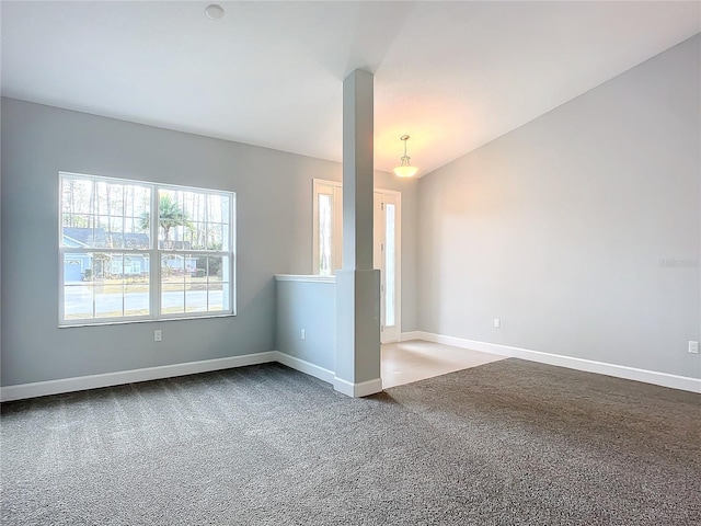 carpeted empty room with lofted ceiling