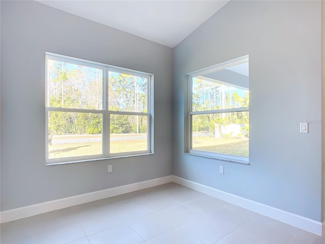 spare room featuring vaulted ceiling