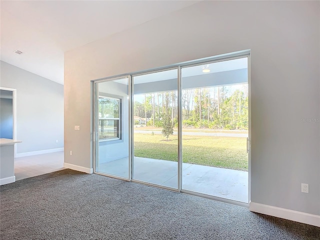 doorway with vaulted ceiling and carpet