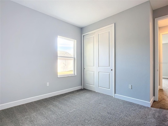 unfurnished bedroom with carpet floors and a closet