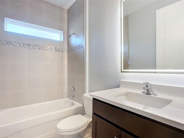 full bathroom featuring vanity, toilet, and tiled shower / bath combo