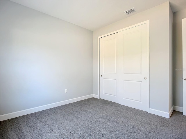 unfurnished bedroom featuring carpet floors and a closet