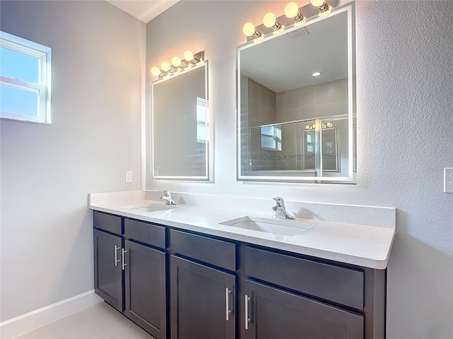 bathroom with vanity, tile patterned floors, and walk in shower