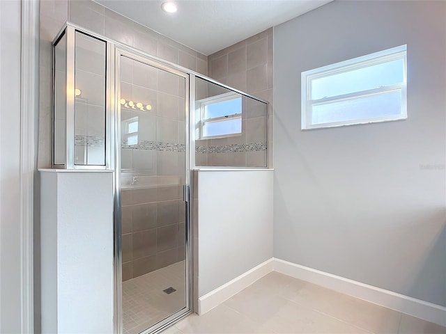 bathroom with tile patterned floors and a shower with door