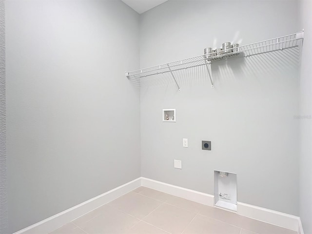 clothes washing area featuring tile patterned floors, washer hookup, and hookup for an electric dryer