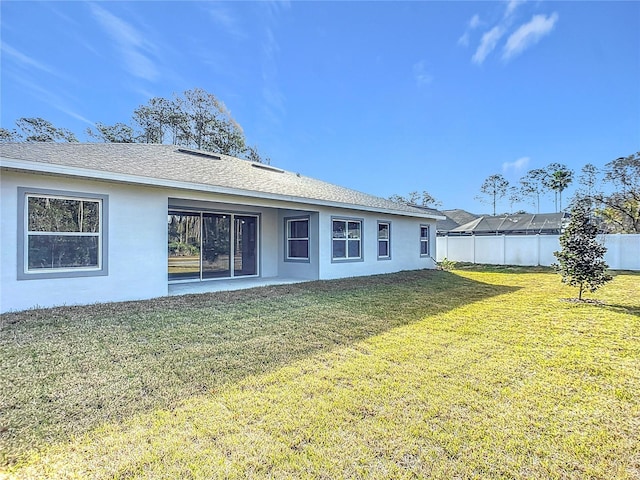 back of house with a yard