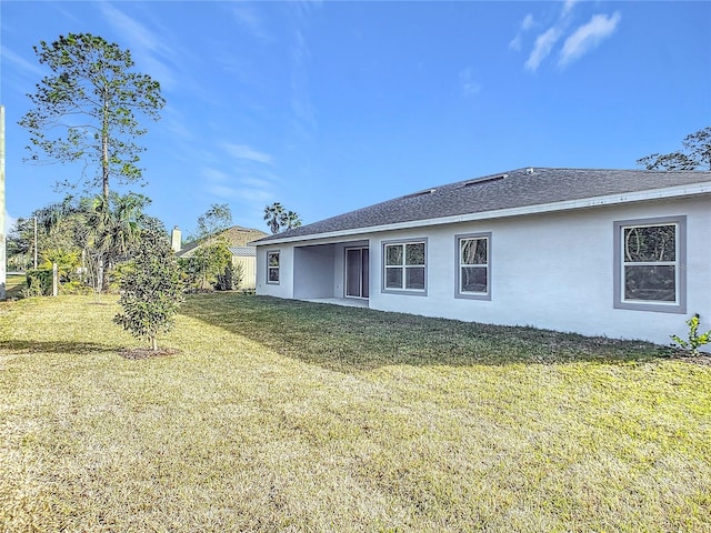 rear view of property featuring a yard