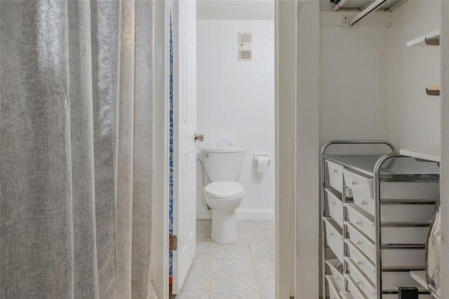 bathroom featuring tile patterned floors and toilet