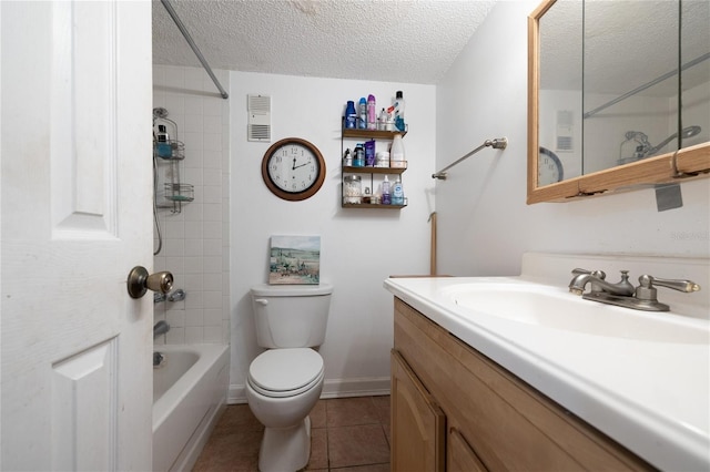 full bathroom featuring tile patterned flooring, vanity, tiled shower / bath combo, toilet, and a textured ceiling