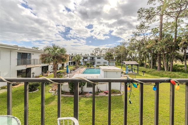 view of pool featuring a lawn