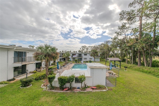 view of pool featuring a patio and a yard