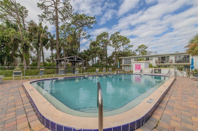 view of swimming pool featuring a gazebo and a patio