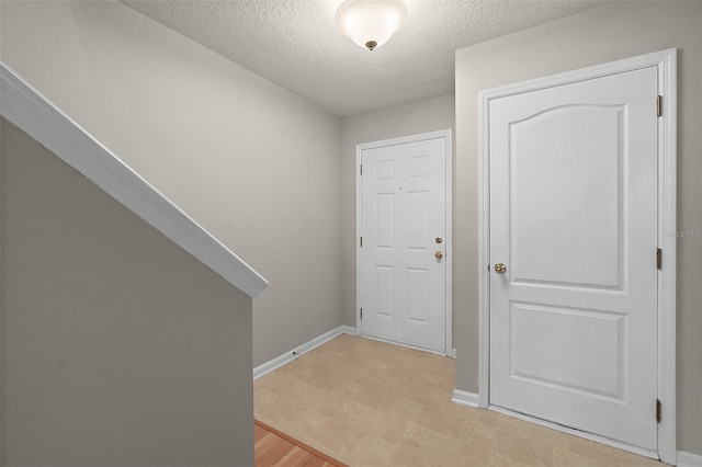 entrance foyer with a textured ceiling