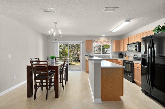 kitchen featuring sink, hanging light fixtures, black appliances, a kitchen island, and light brown cabinets