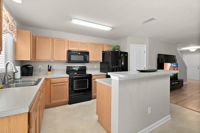 kitchen featuring a kitchen island, sink, light brown cabinetry, and black appliances