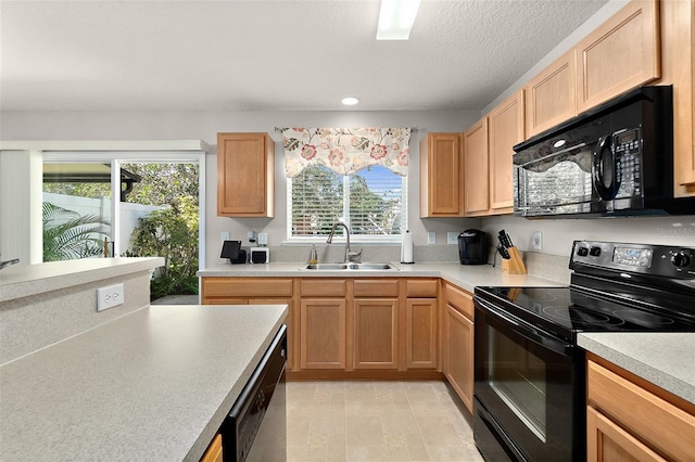 kitchen featuring sink, black appliances, and a textured ceiling