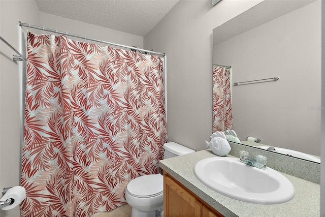 bathroom featuring vanity, a textured ceiling, and toilet