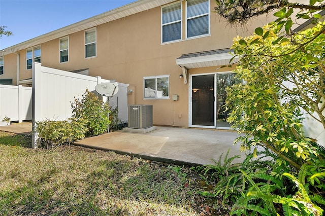 rear view of house with a patio and central AC unit