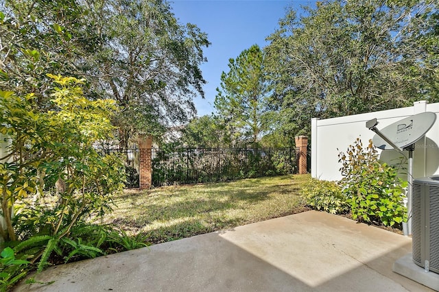 view of yard featuring central AC and a patio area