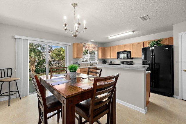 dining space with an inviting chandelier, sink, and a textured ceiling