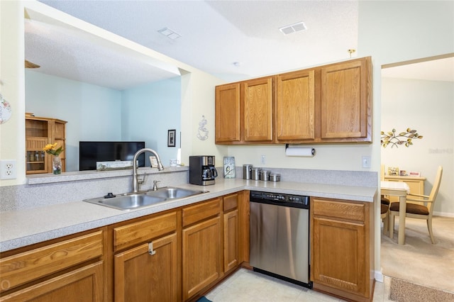 kitchen with light colored carpet, stainless steel dishwasher, kitchen peninsula, and sink