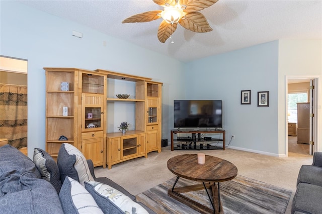 carpeted living room featuring lofted ceiling, a textured ceiling, and ceiling fan