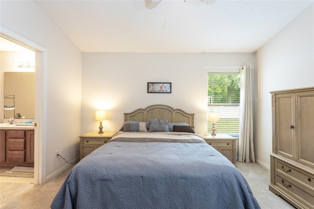 carpeted bedroom featuring ensuite bath