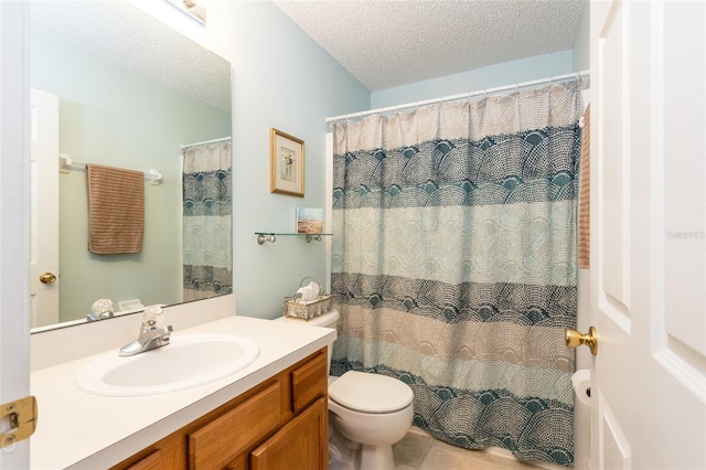 bathroom with vanity, curtained shower, toilet, and a textured ceiling