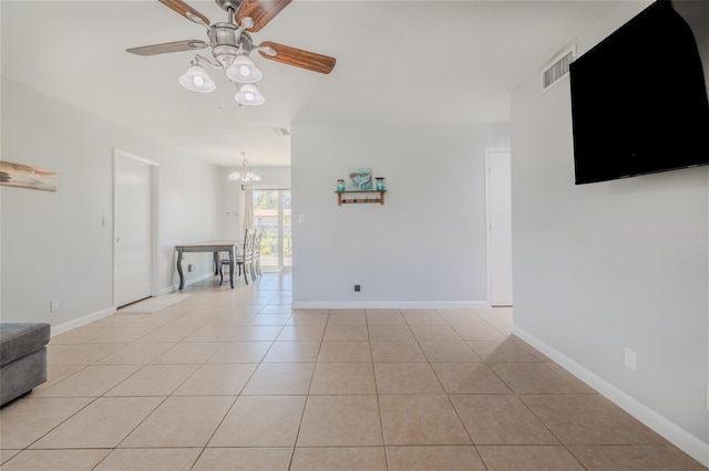 unfurnished living room featuring ceiling fan with notable chandelier and light tile patterned flooring