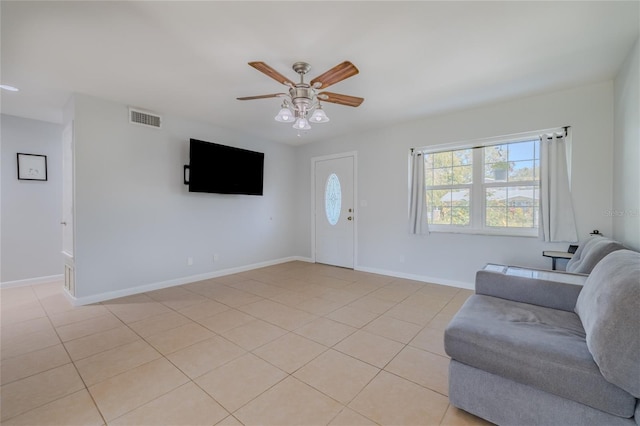 tiled living room with ceiling fan