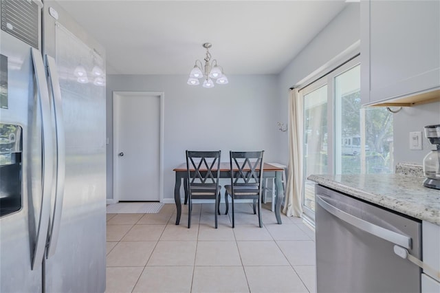 dining space with an inviting chandelier and light tile patterned floors